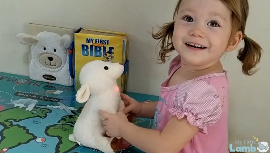 Little Girl playing with My Little Lamb, a plushie with integrated audio player